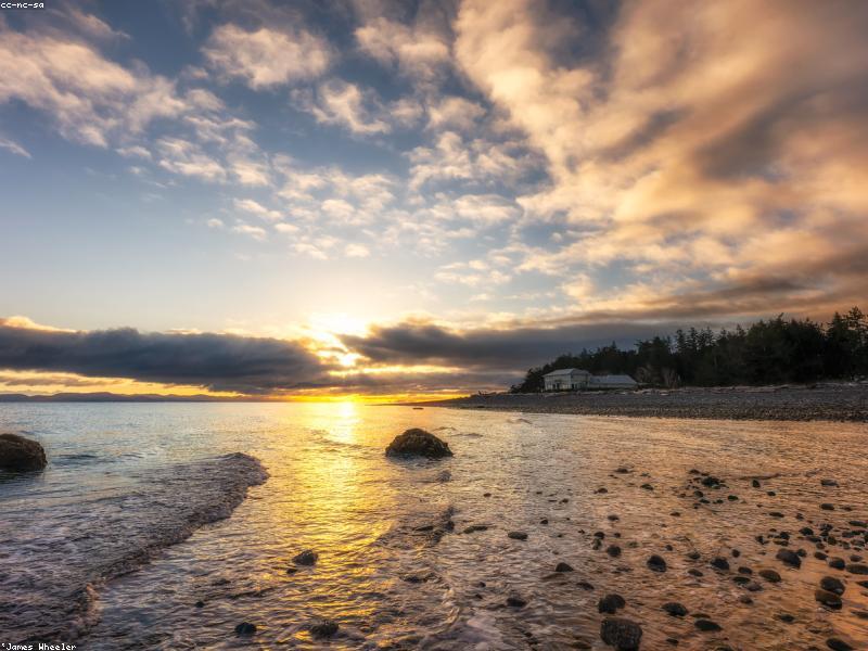 Beautiful landscape of mountains and a lake at sunset, photorealistic, 8k